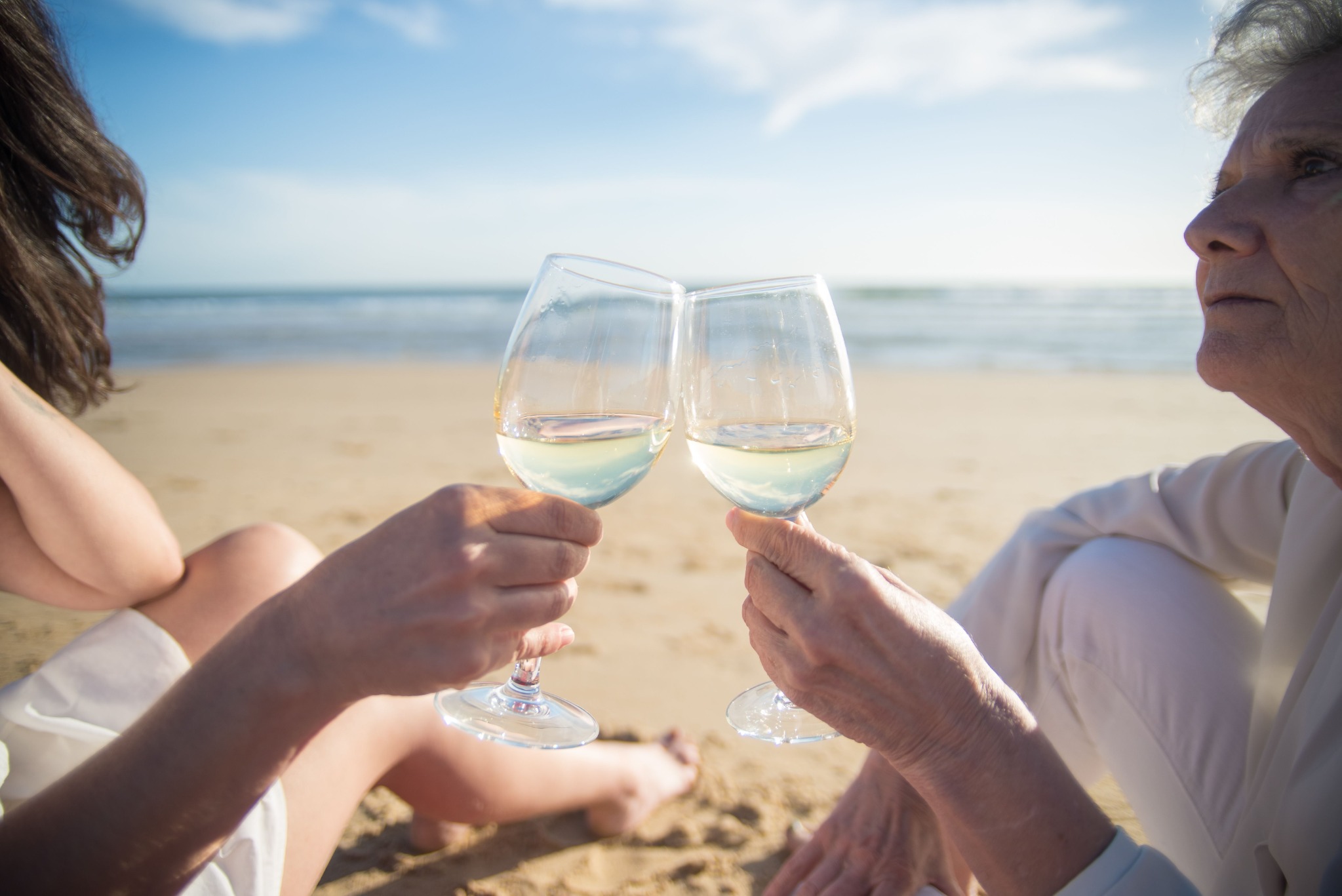 Two adults enjoying a shared moment on a sunny beach